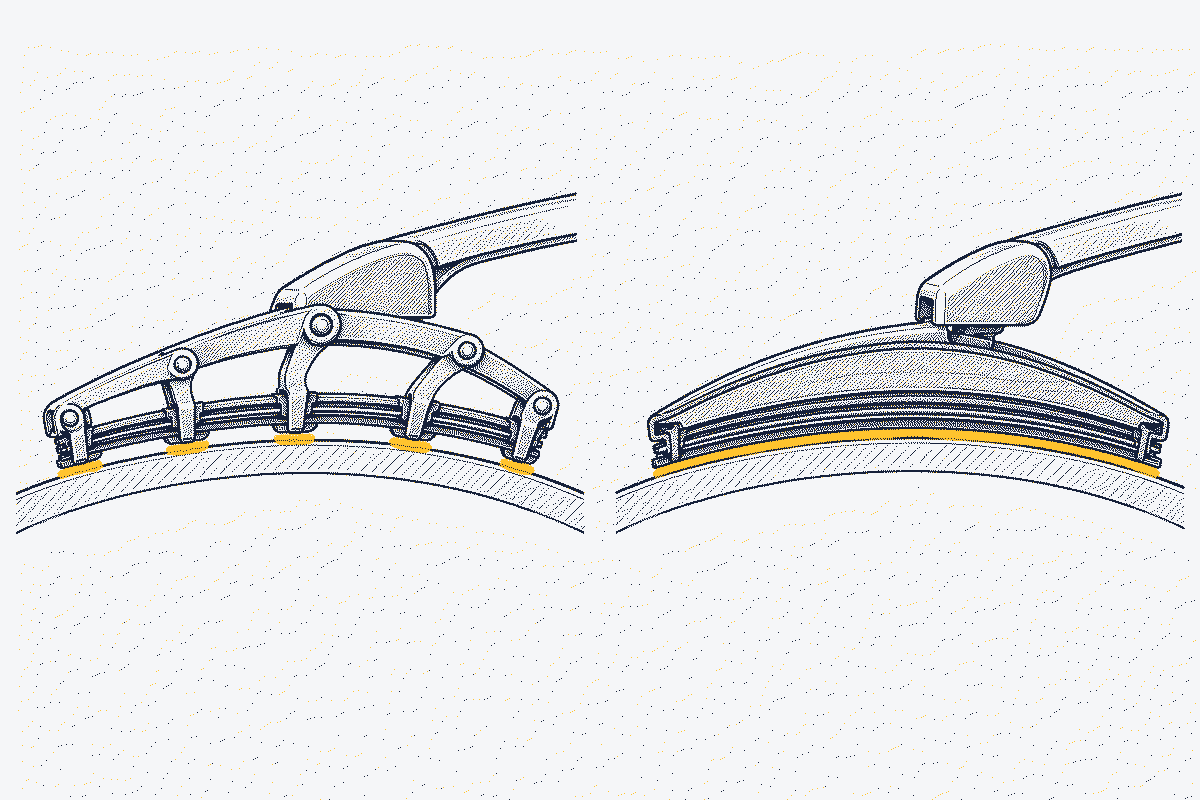 Cutaway of a framed wiper blade's claws and a flat blade's continuous spine pressing on a curved windscreen
