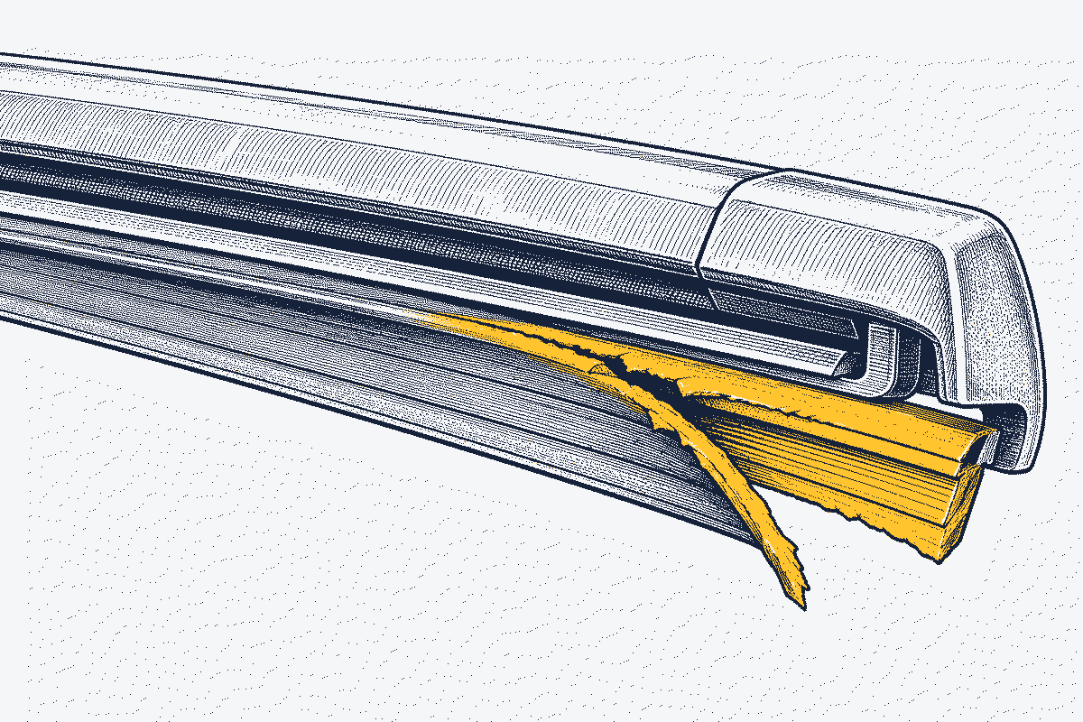 Close-up of a wiper blade rubber edge that is split and peeling away from the blade